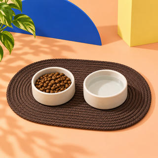 Brown waxed cord dog bowl mat with two bowls on it