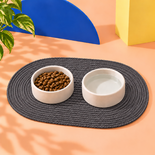 Grey waxed cord dog bowl mat with two bowls on it