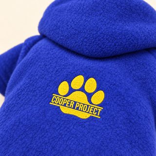 Close-up of the embroidered Cooper Project paw on royal fleece