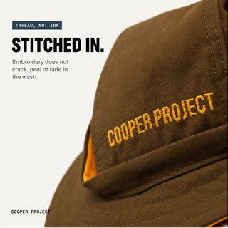 Close-up of the embroidery on the Khaki Dog Bucket Hat — Yellow Lining