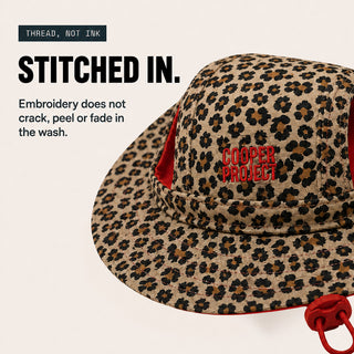 Close-up of the embroidery on the Leopard Dog Bucket Hat — Red Lining
