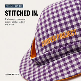 Close-up of the embroidery on the Purple Check Dog Bucket Hat — Red Lining