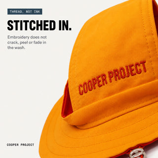 Close-up of the embroidery on the Yellow Dog Bucket Hat — Red Lining